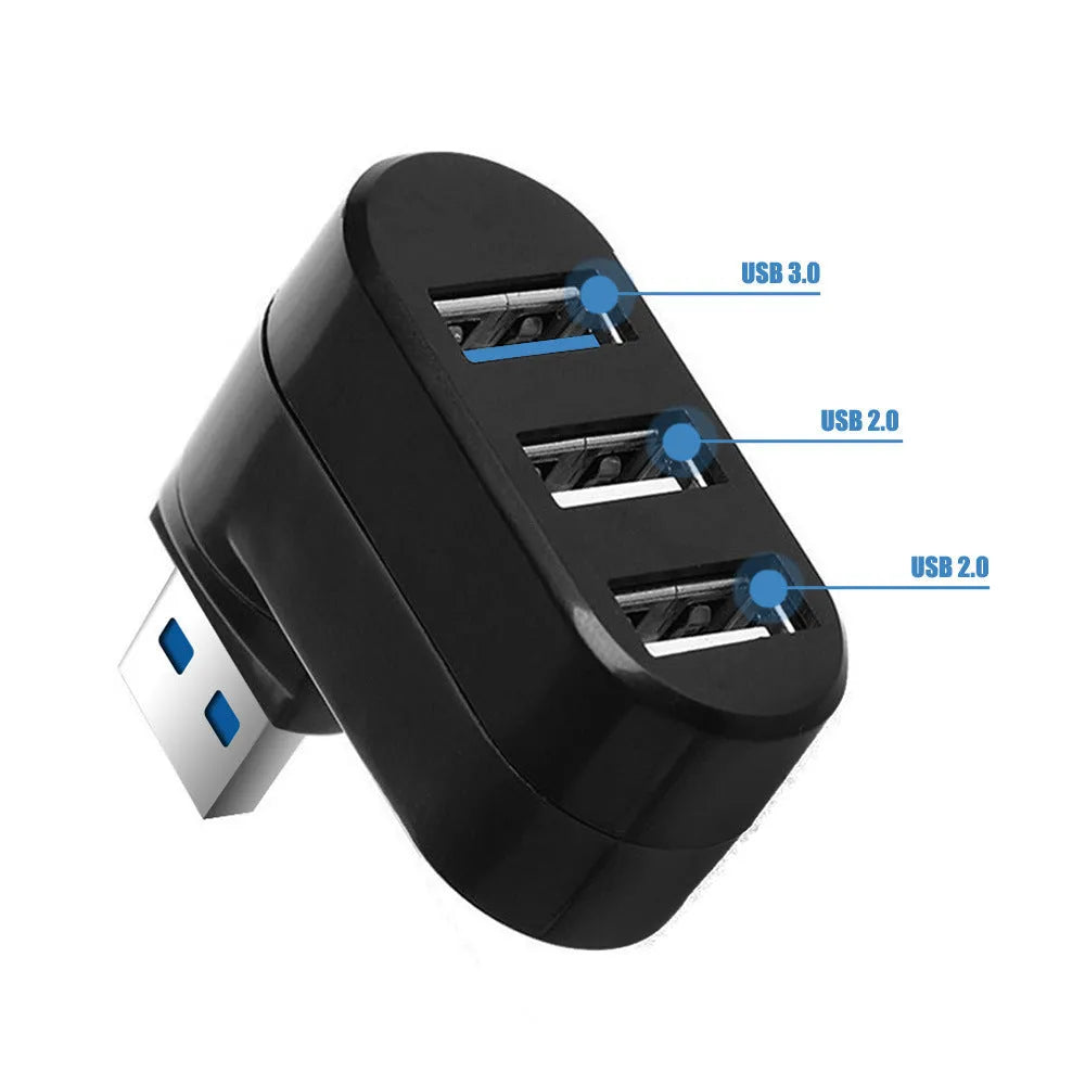 Black and white USB 3.0 four-port rotary hub on a desk next to a laptop