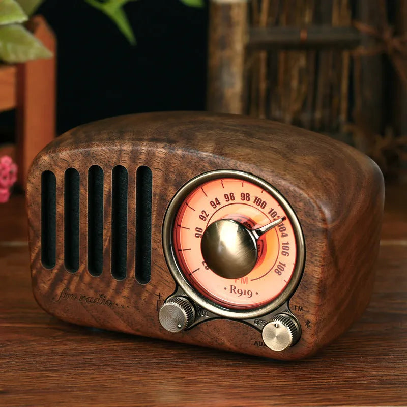 Retro wooden wireless mini speaker in cherry wood finish showing compact size.