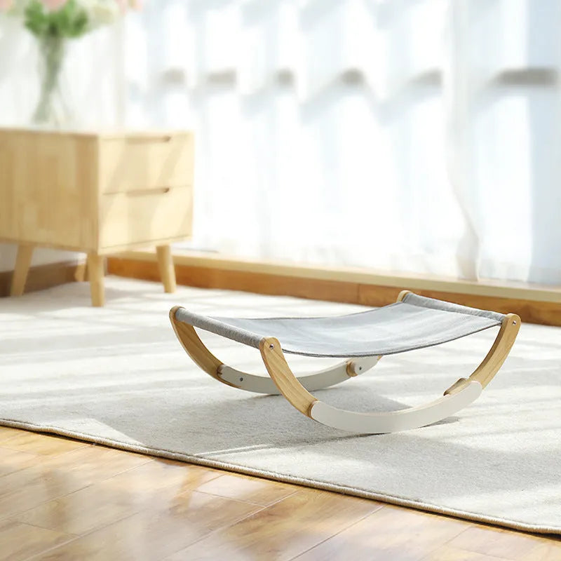 Solid wood cat bed with grey cloth cushion and anti-slip mat base, raised off-ground design
