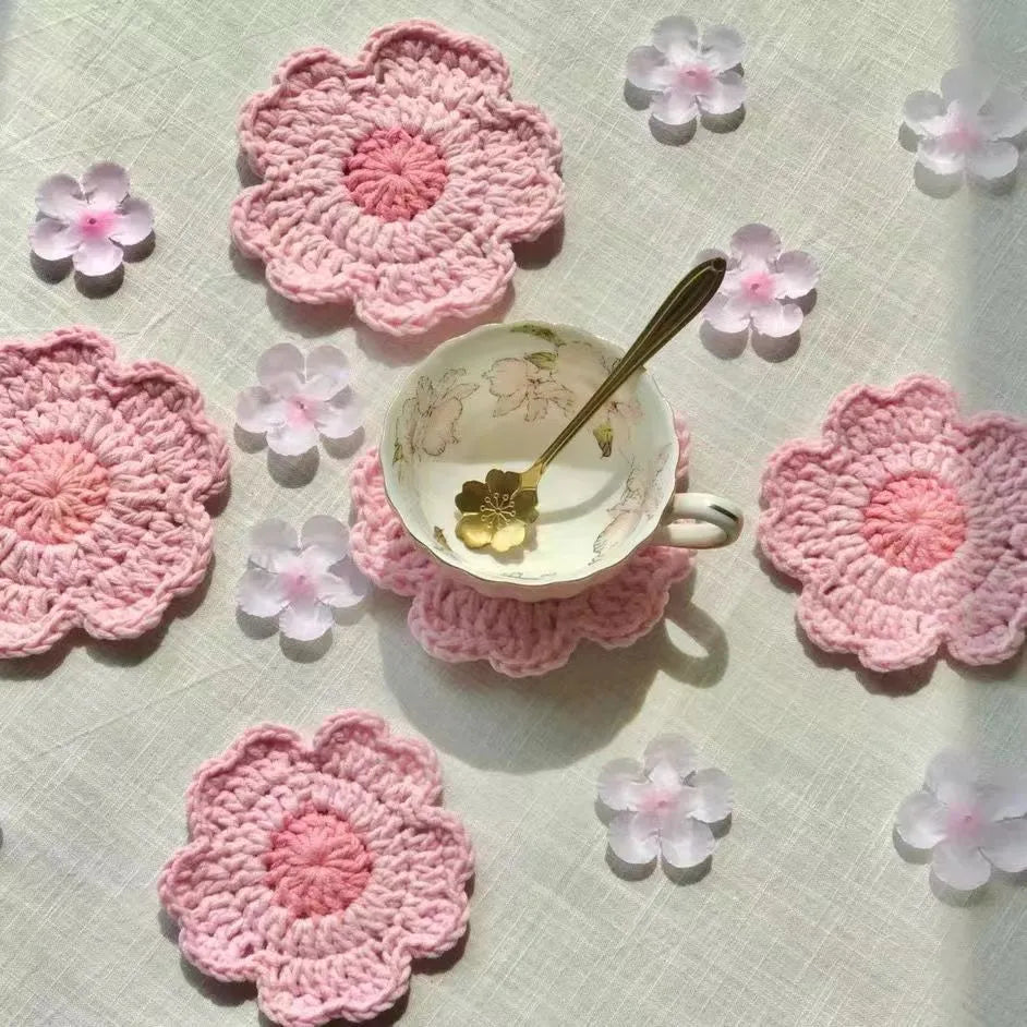 Hand-woven wool drink coaster on a wooden table