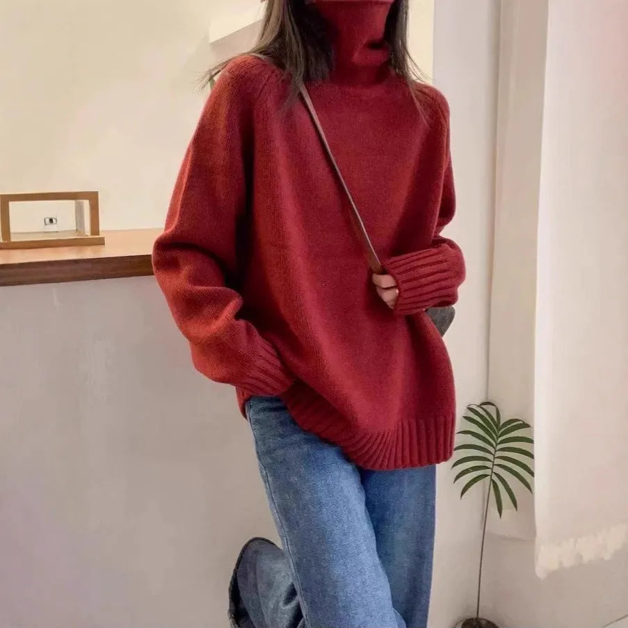 Women's loose grey turtleneck sweater with a thick curling pile collar and 3D pattern texture.