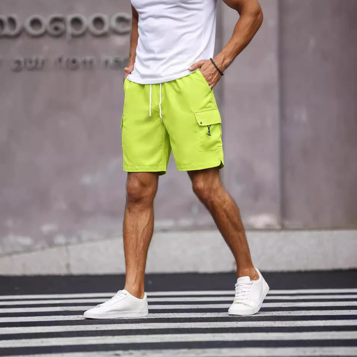 Men's loose-fitting straight-leg work shorts in fluorescent green cool silk cotton fabric.