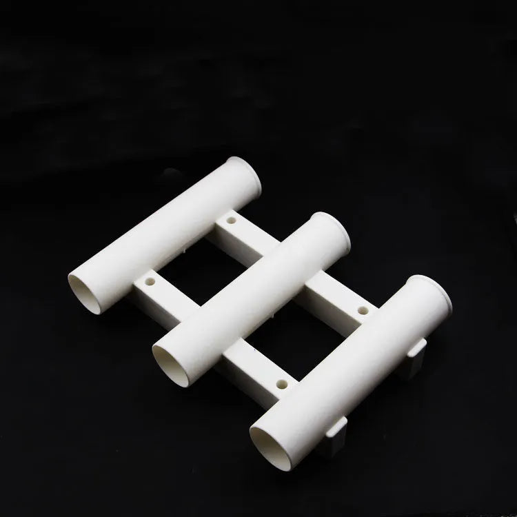 Black or white 3-hole sea fishing rod turret in ABS plastic, 31.5cm x 22.6cm x 6.5cm, with 5cm rod holes.