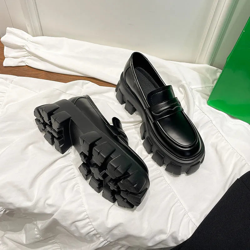 British style wide fit loafers in matte or patent leather with a rubber sole and muffin heel.