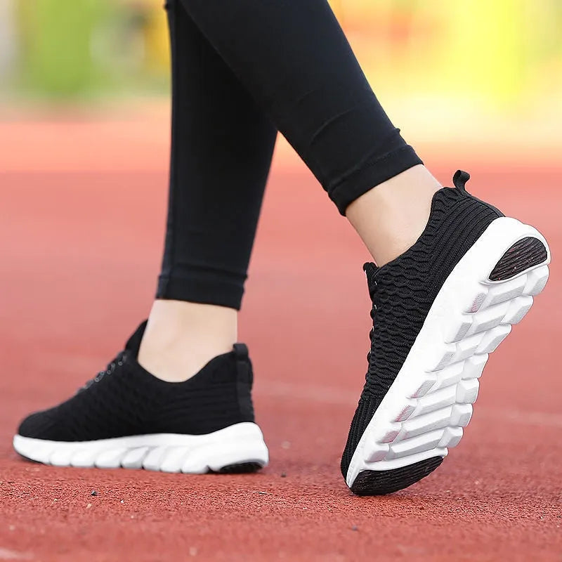 Women's running shoes in black, pink, or white with fly weave upper and wear-resistant outsole