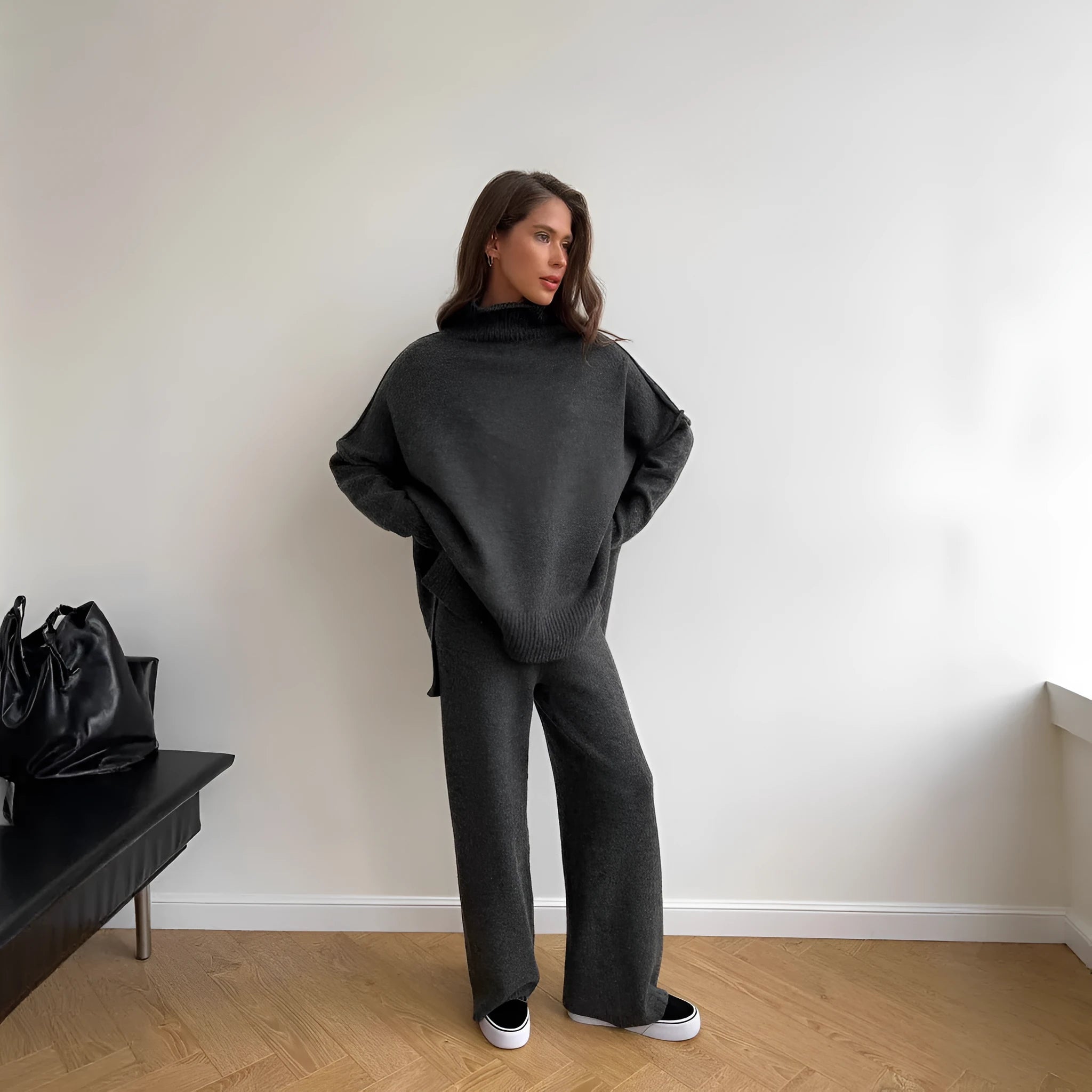 Women's dark grey acrylic knit co-ord set with side-slit sweater and matching trousers laid flat.