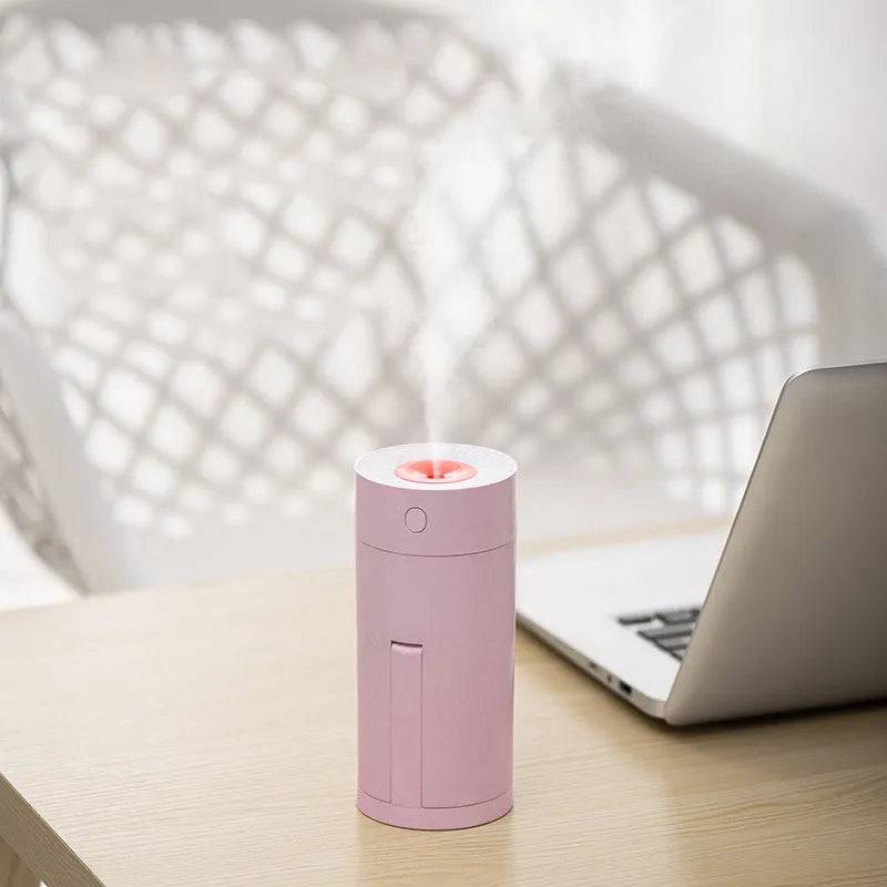 Blue folding bracket USB desktop humidifier with water tank on a wooden desk
