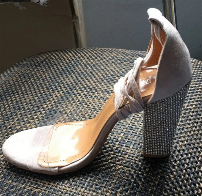 A pair of black pointed-toe high heels for women with a plastic upper and sole.