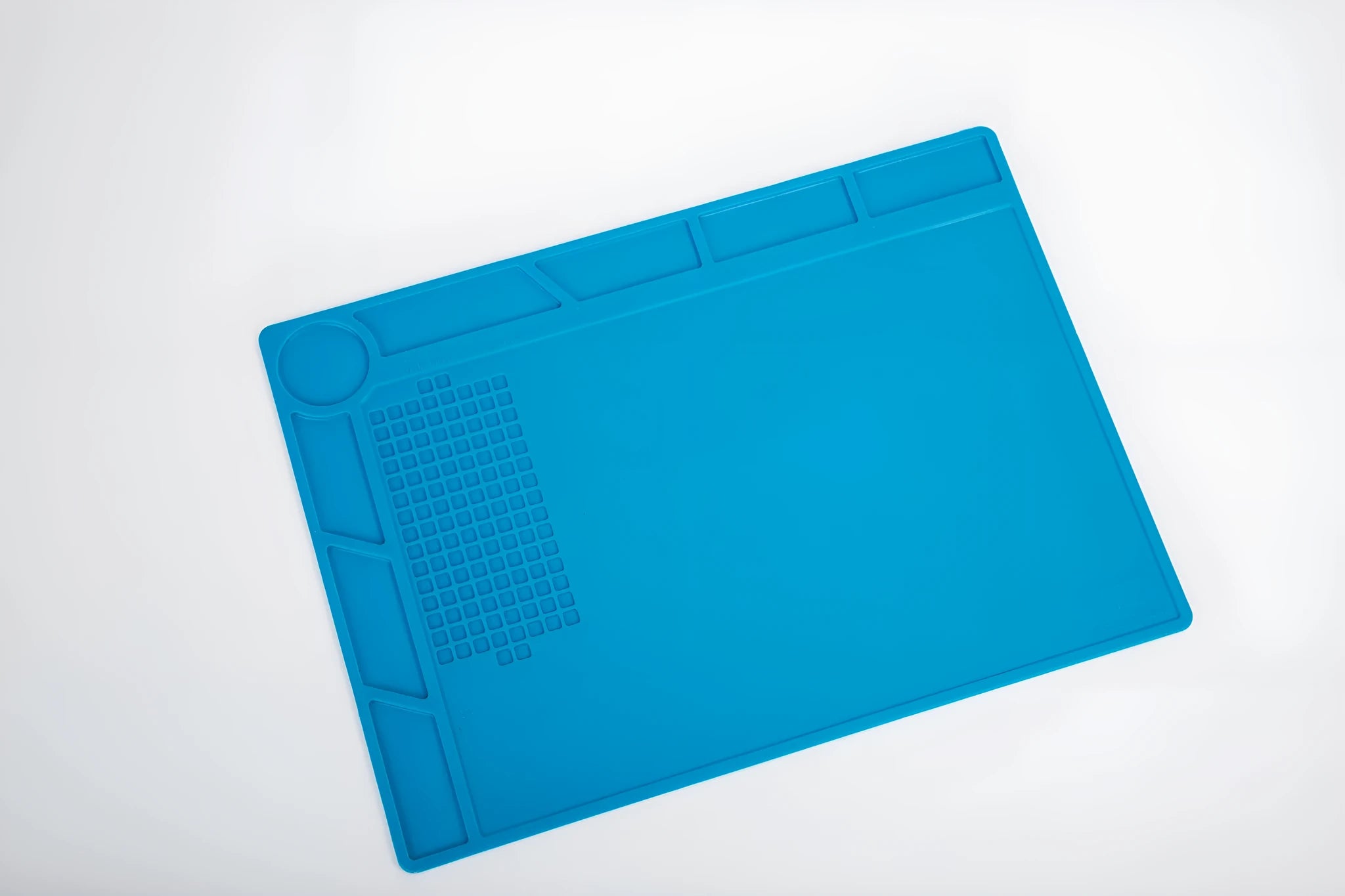 Blue silicone watch repair desk mat with anti-slip textured surface for jewellery tools