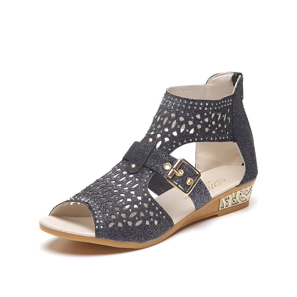 Women's beige flat sandals with rivet detailing, wedge heel, and back zip fastening.