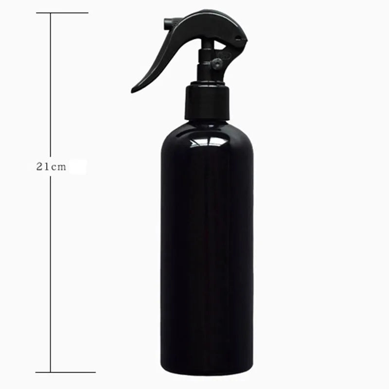 Black plastic and metal mini garden tool set for succulents, with tools laid out on a 75cm square cushion.