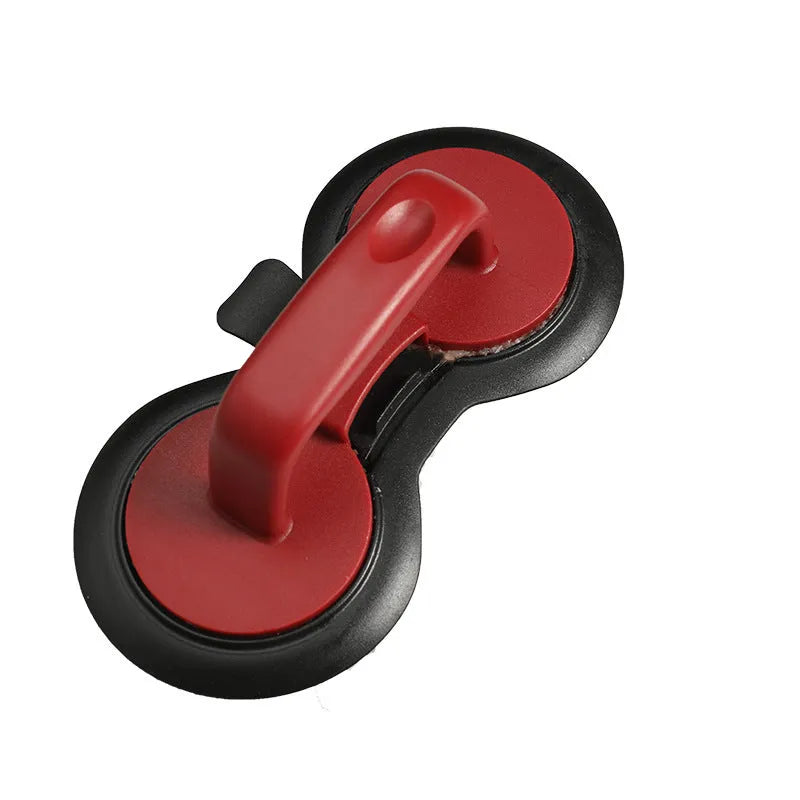 Black food-grade ABS burger press kitchen gadget on a kitchen counter.
