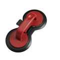 Black food-grade ABS burger press kitchen gadget on a kitchen counter.