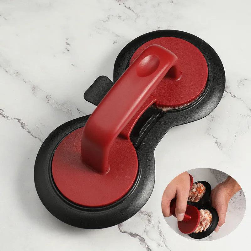 Black food-grade ABS burger press kitchen gadget on a kitchen counter.