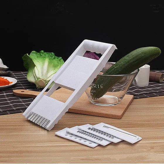 White home kitchen multifunctional grater set with stainless steel blades, hand guard, and main body measuring 28.3 by 13.2 cm.