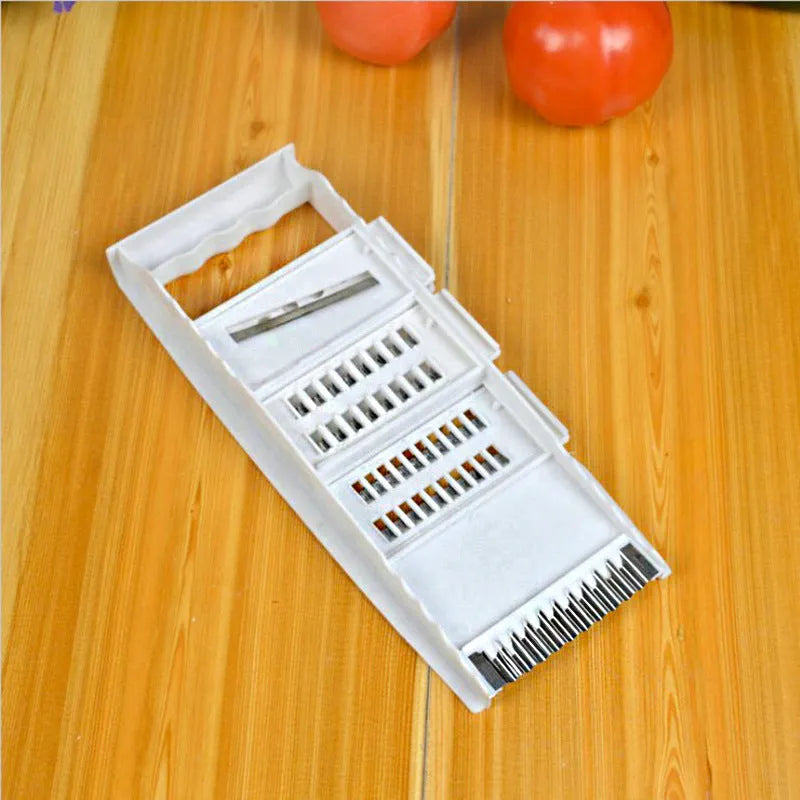 White home kitchen multifunctional grater set with stainless steel blades, hand guard, and main body measuring 28.3 by 13.2 cm.
