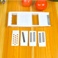 White home kitchen multifunctional grater set with stainless steel blades, hand guard, and main body measuring 28.3 by 13.2 cm.