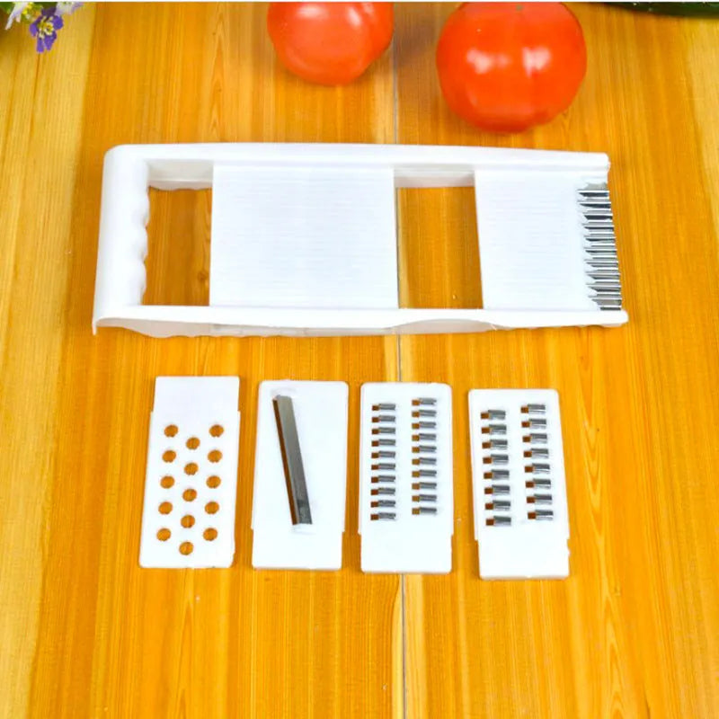 White home kitchen multifunctional grater set with stainless steel blades, hand guard, and main body measuring 28.3 by 13.2 cm.