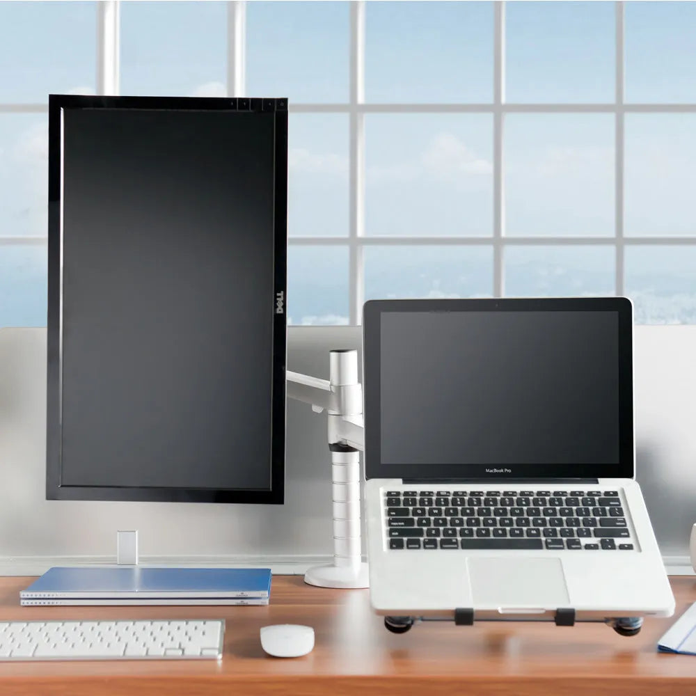 Silver metal dual-purpose bracket holding a notebook and monitor on a desk with adjustable arm