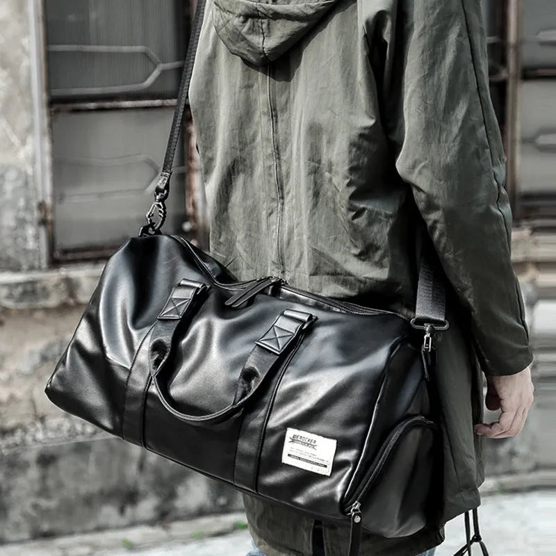 Large black waterproof PU leather sports bag showing internal organiser with laptop and camera pockets.