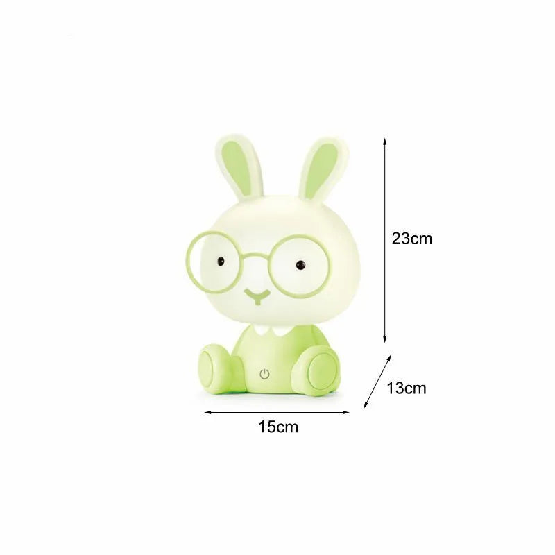 Blue USB cartoon rabbit night light with glasses on a table, showing dimmer switch.