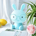 Blue USB cartoon rabbit night light with glasses on a table, showing dimmer switch.