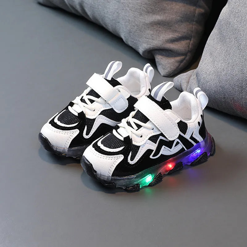 Black, pink, and grey children's Velcro sneakers with mesh panels and a rubber sole.