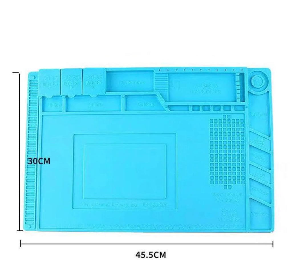 Blue mobile phone computer repair magnetic heat insulation work mat on a desk