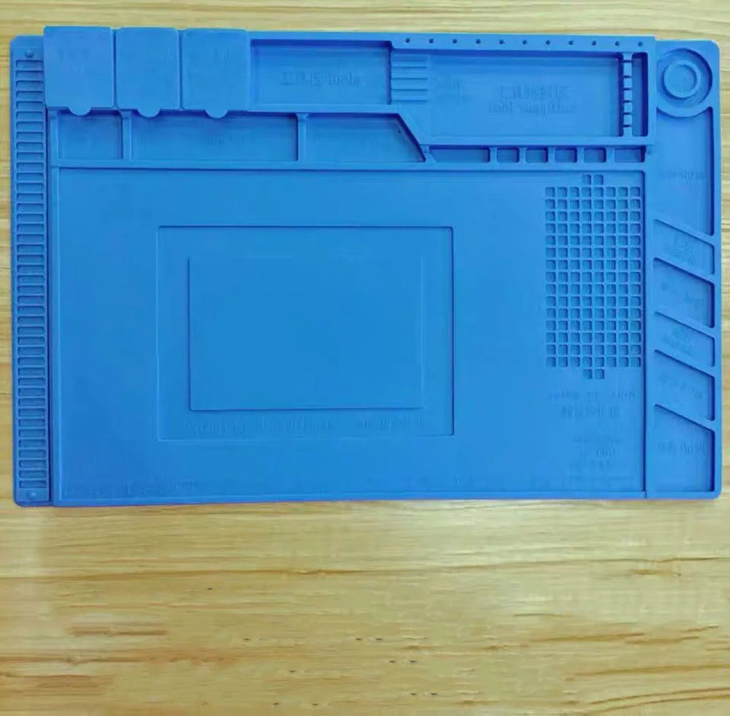 Blue mobile phone computer repair magnetic heat insulation work mat on a desk