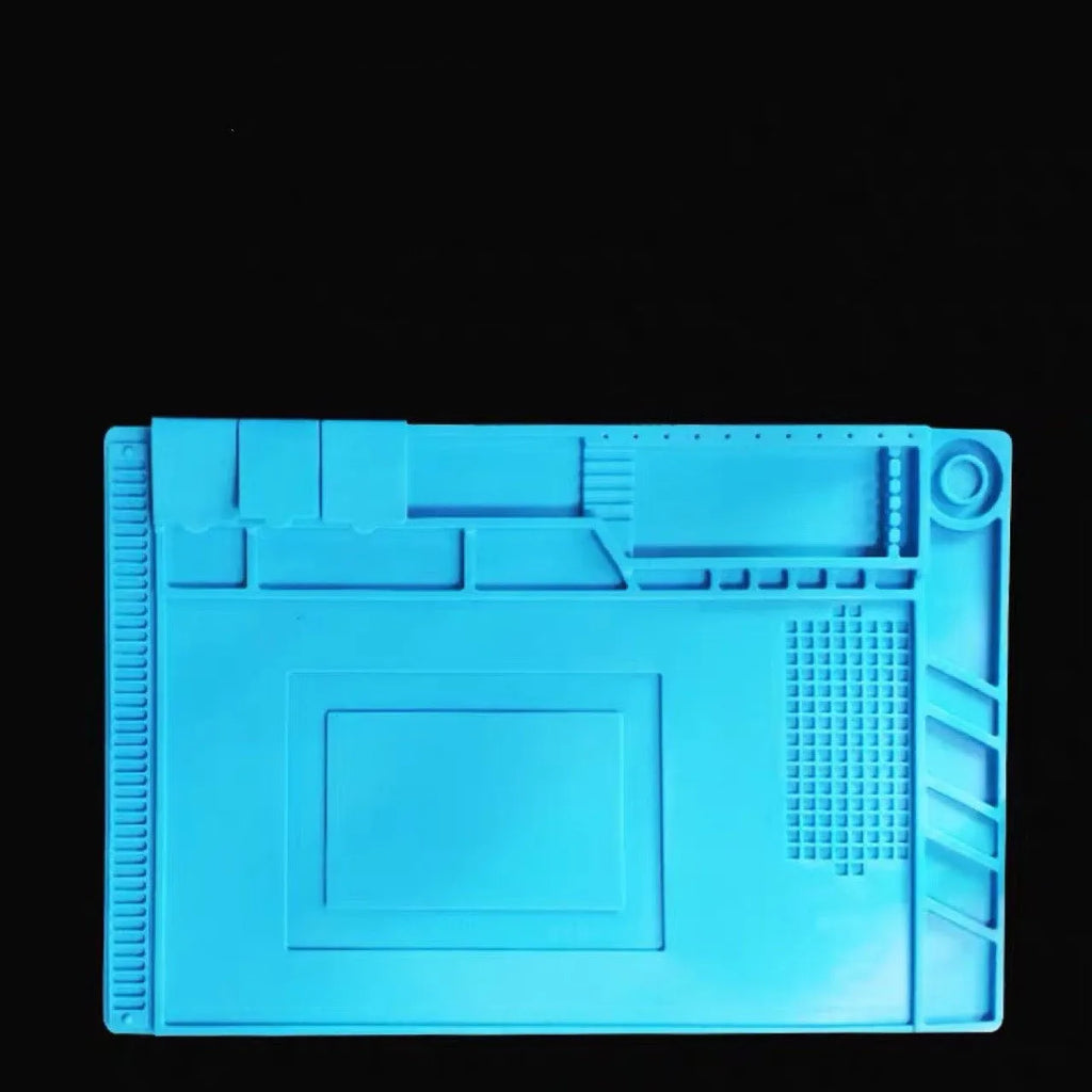 Blue mobile phone computer repair magnetic heat insulation work mat on a desk