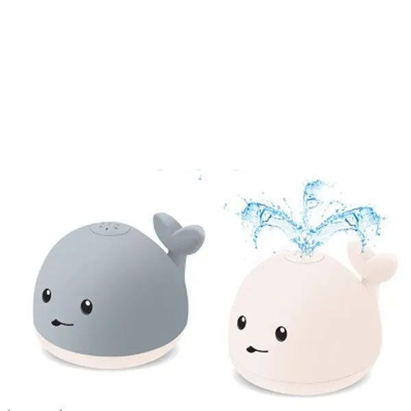Grey and white whale bath toy spraying water with LED lights on water surface