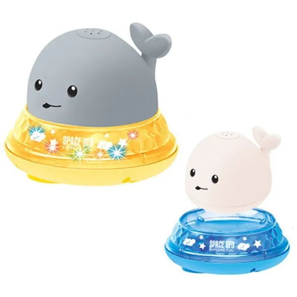 Grey and white whale bath toy spraying water with LED lights on water surface