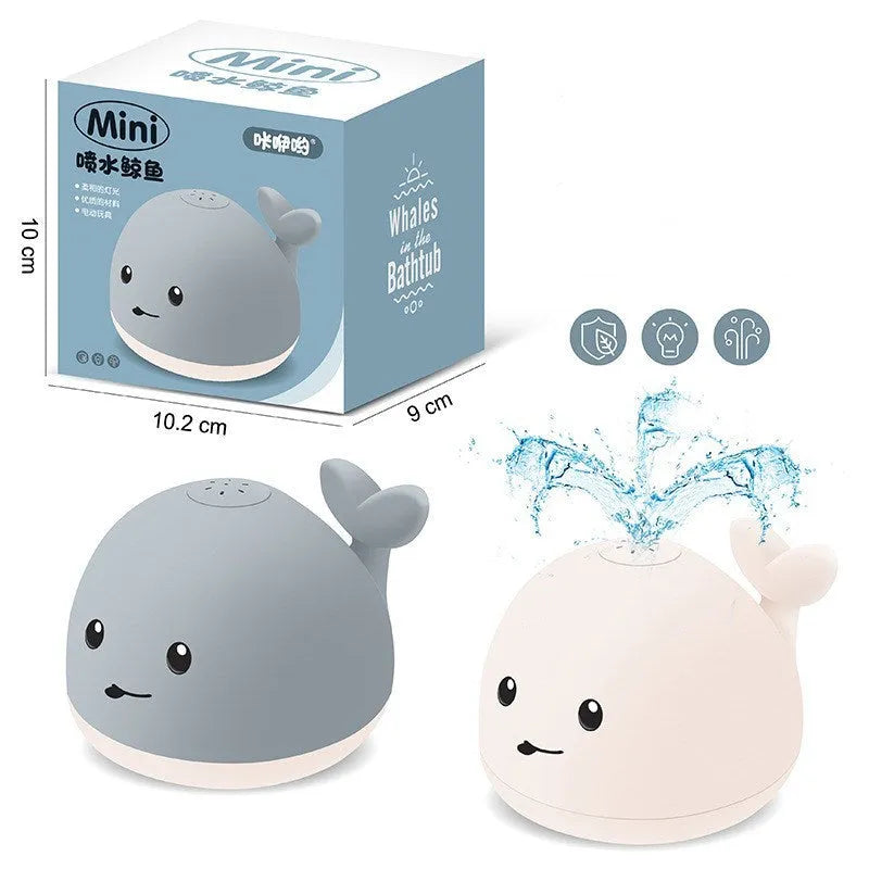 Grey and white whale bath toy spraying water with LED lights on water surface