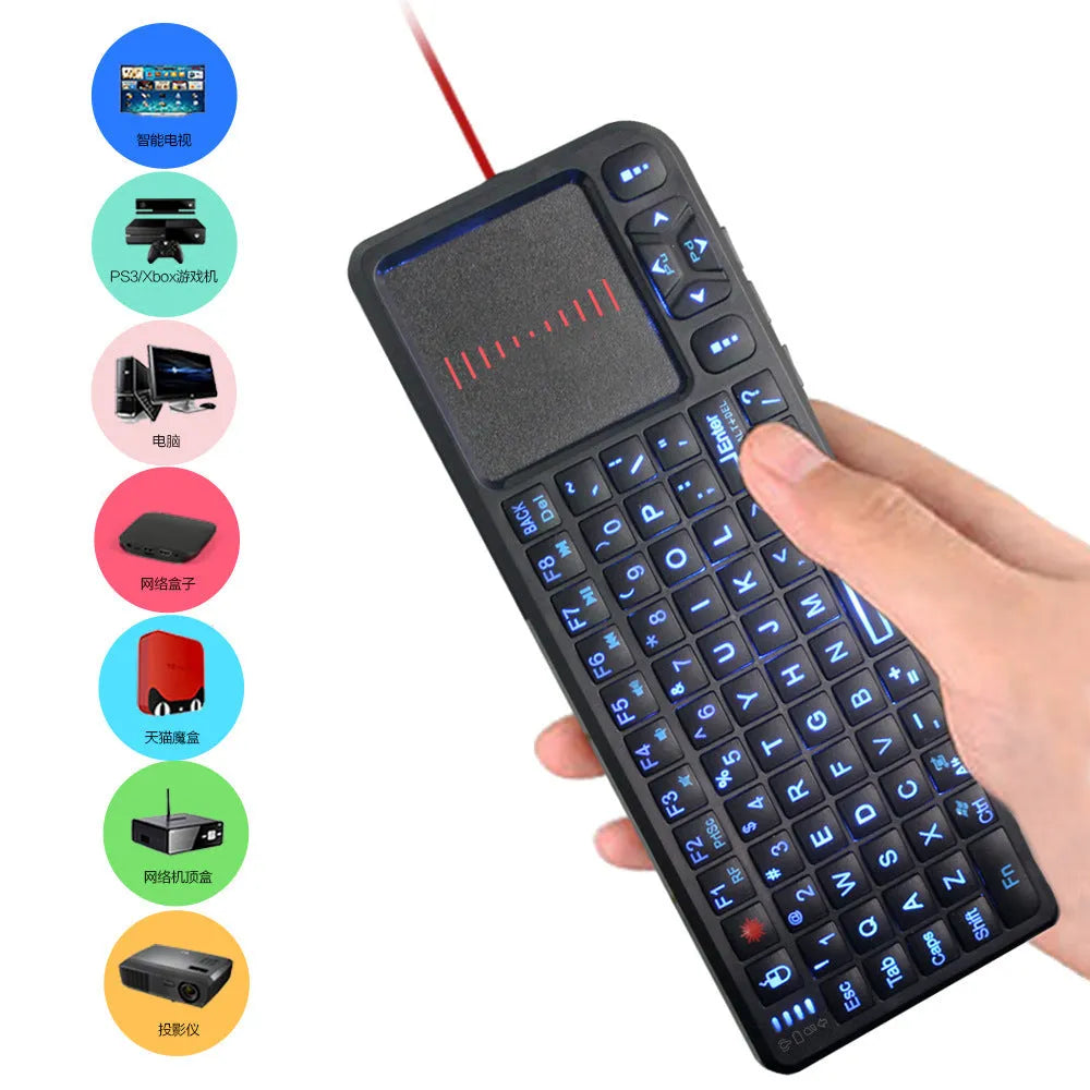 Black wireless mini keyboard with touch screen and matching optical mouse on a desk.