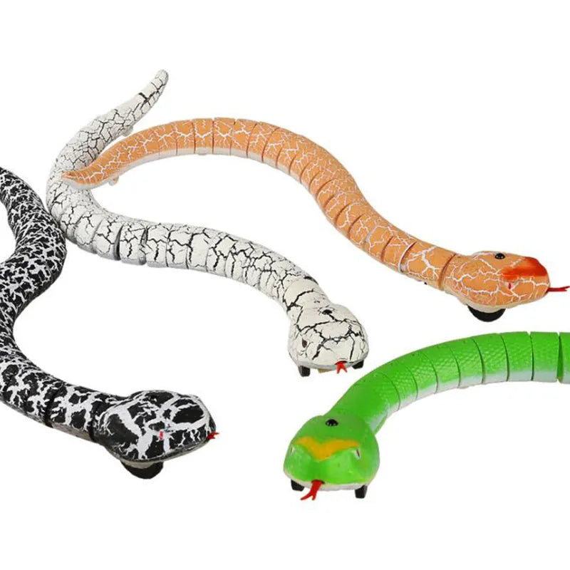 Remote control black cobra snake toy with USB charging cable and batteries on floor
