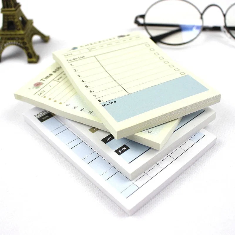 Compact work plan diary notebook showing four different design style options for weekly and monthly planning