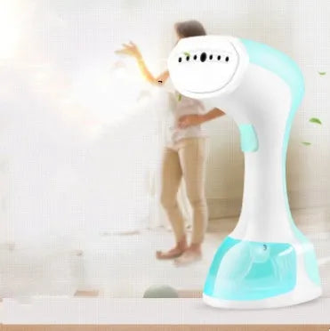 Mini portable handheld garment steamer with 0.9L water tank in green with brush accessory on white background