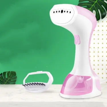 Mini portable handheld garment steamer with 0.9L water tank in green with brush accessory on white background