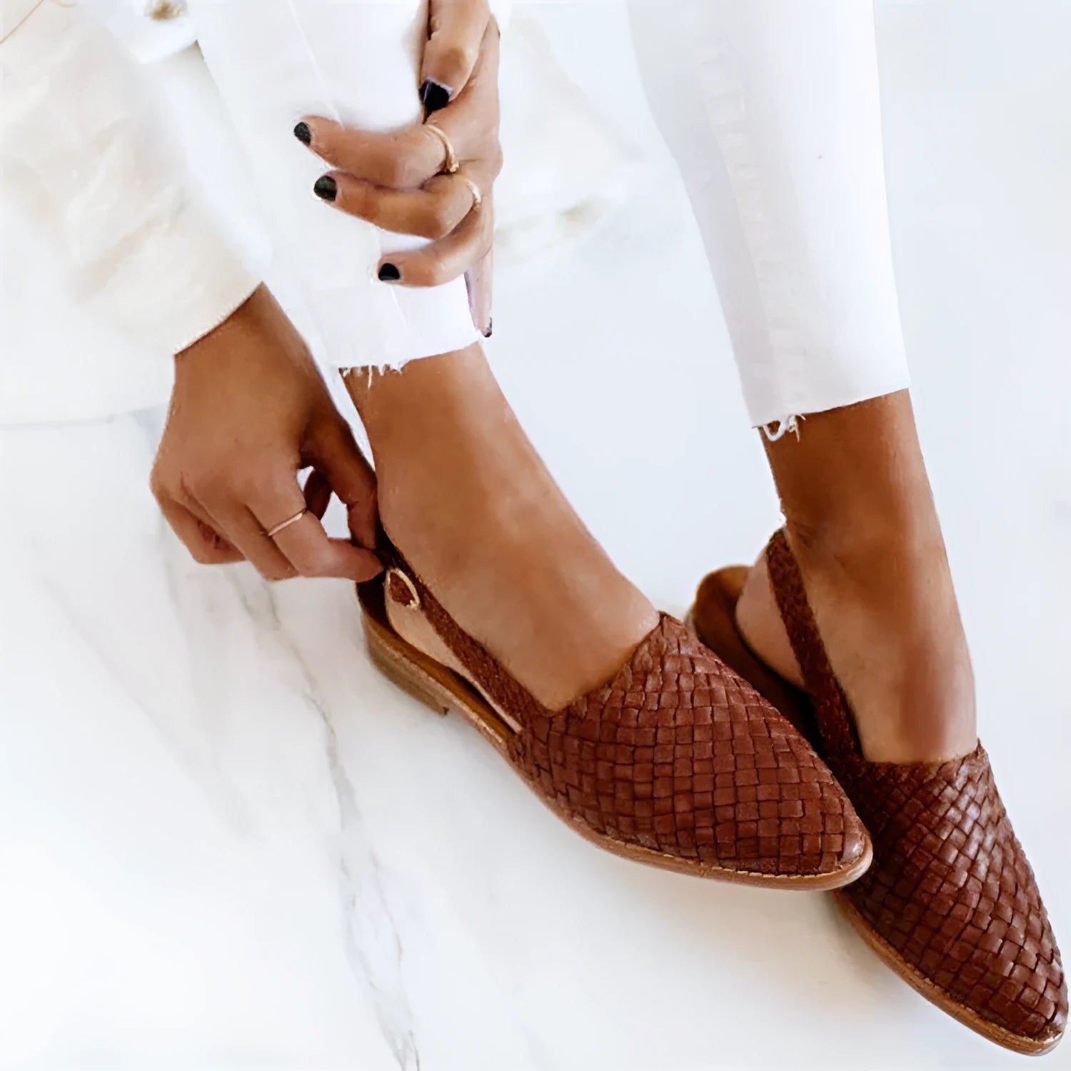 A pair of pointed toe, baotou flat sandals with a central buckle fastening, shown in a selection of colours.