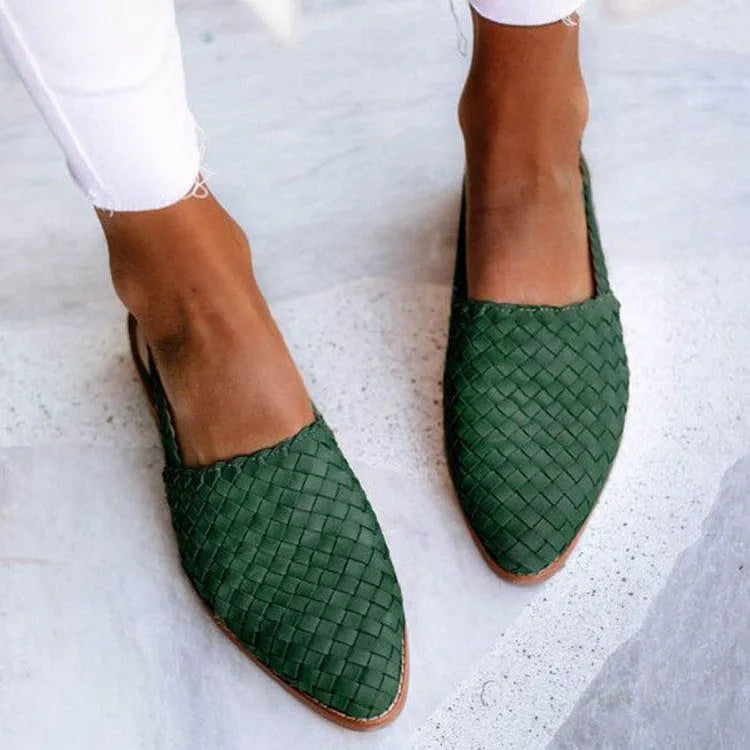 A pair of pointed toe, baotou flat sandals with a central buckle fastening, shown in a selection of colours.