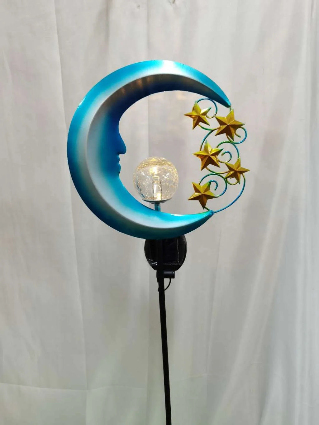 Blue solar garden light with hollow wrought iron moon design and moon crack glass ball