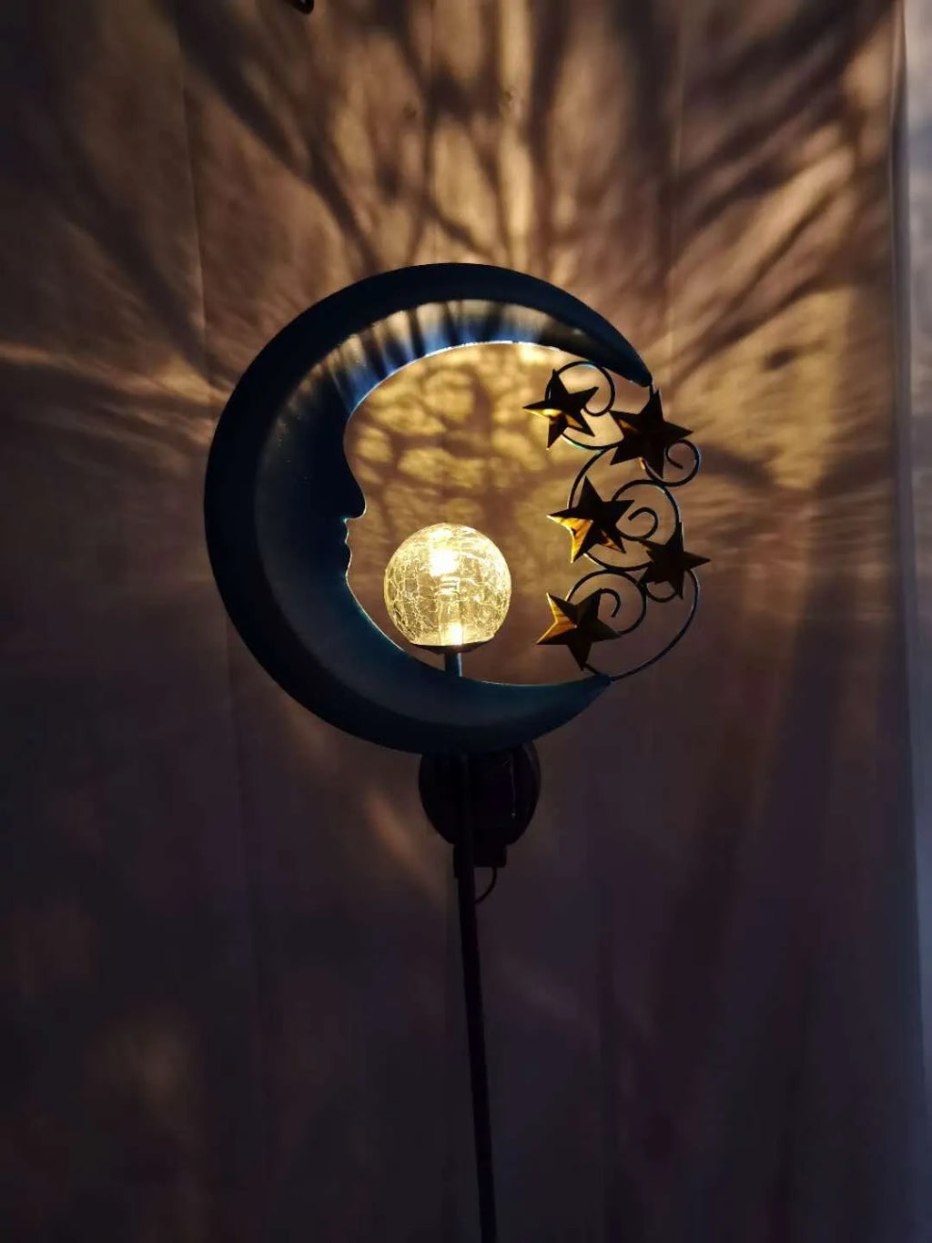 Blue solar garden light with hollow wrought iron moon design and moon crack glass ball