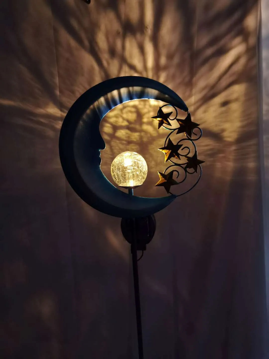 Blue solar garden light with hollow wrought iron moon design and moon crack glass ball