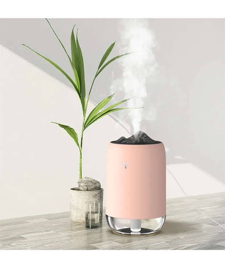 Magic Flame white mini ultrasonic humidifier with USB cable on desktop, columnar shape
