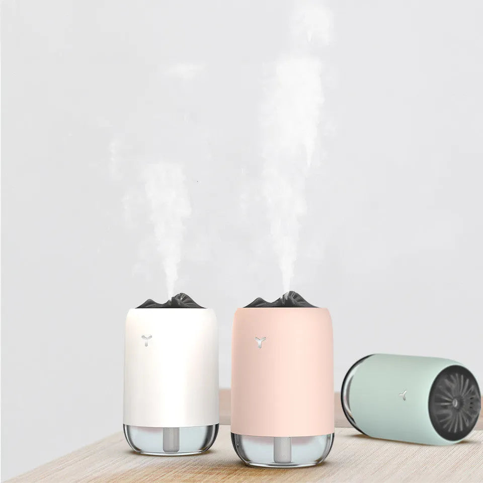 Magic Flame white mini ultrasonic humidifier with USB cable on desktop, columnar shape