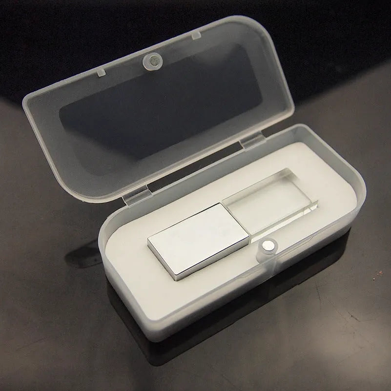 Transparent glass USB flash drive with stainless steel frame in gold colour showing USB connector