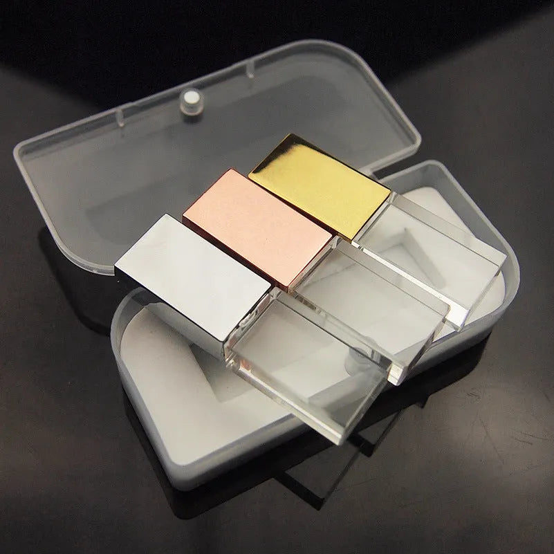 Transparent glass USB flash drive with stainless steel frame in gold colour showing USB connector