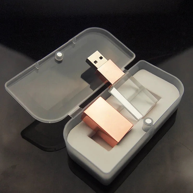Transparent glass USB flash drive with stainless steel frame in gold colour showing USB connector