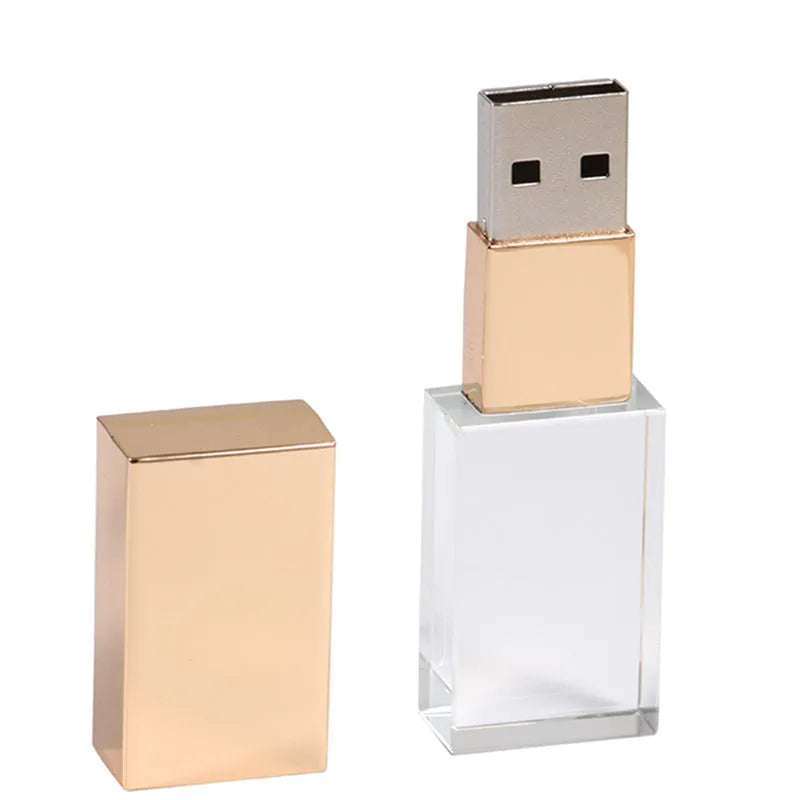 Transparent glass USB flash drive with stainless steel frame in gold colour showing USB connector