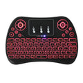 Compact white wireless keyboard with multi-colour backlit keys and a small USB dongle on a desk.